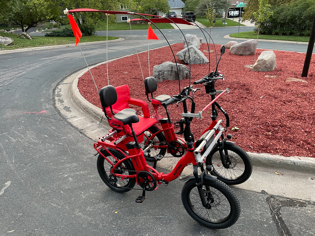 Red eBikes from Rattan connected for inclusive cycling with 3rd rider seat
