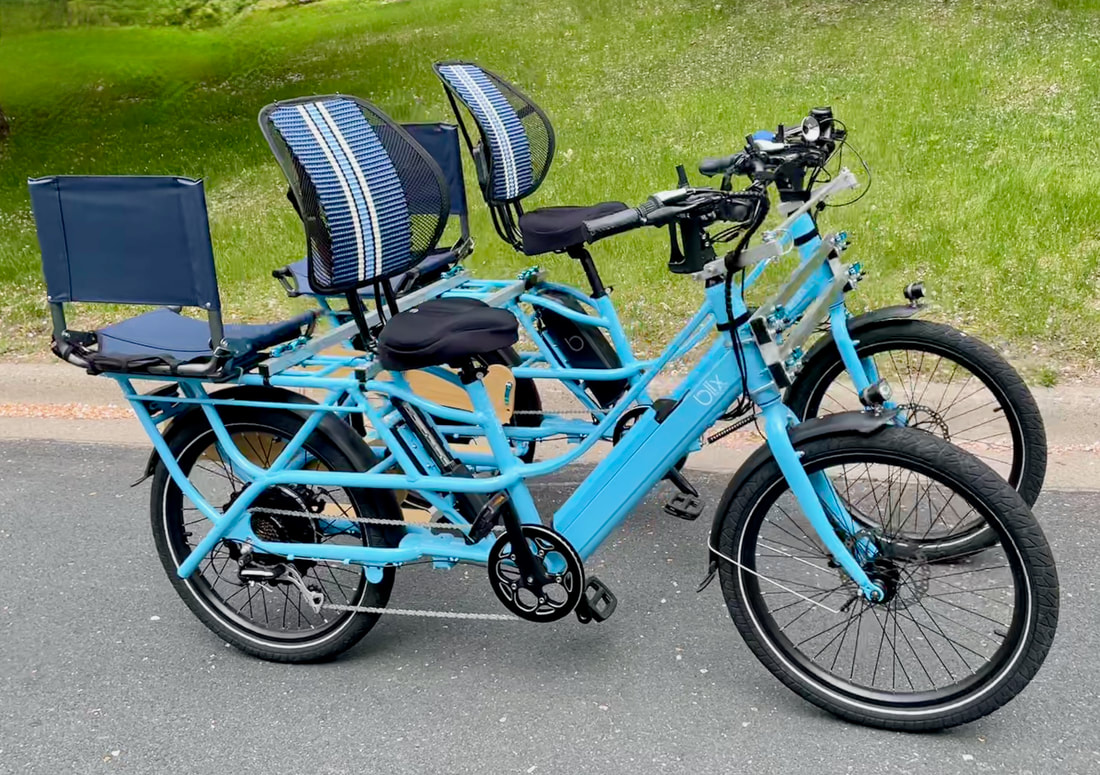 Two electric cargo bicycles attached side by side to make a family bike